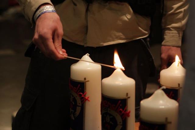 Ein Pfadfinder verteilt die Flamme aus Betlehem